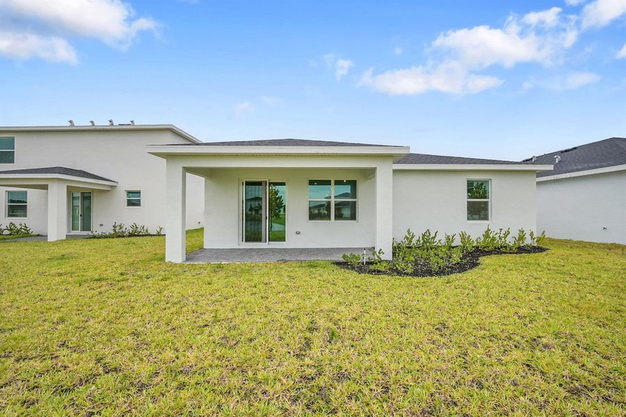 Front exterior of a new home in Seagrove: The Indies, Fort Pierce, FL, highlighting curb appeal (Image 1). Front exterior of a new home in Seagrove: The Indies, Fort Pierce, FL, highlighting curb appeal (Image 1).