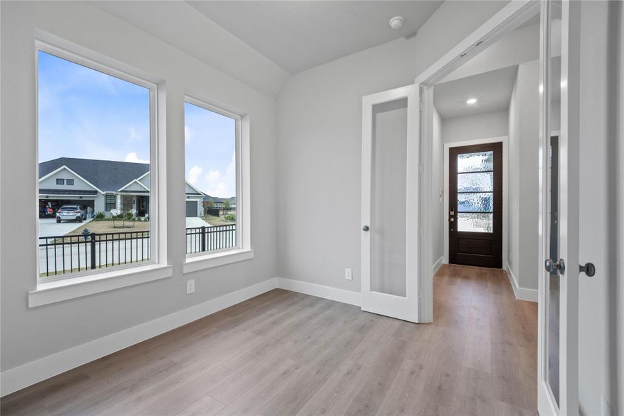 The study/home office is a bright, flexible living space with a strong emphasis on natural light and an open yet defined floor plan, highlighted by the use of French doors.
