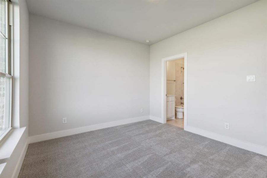 Empty room featuring light carpet