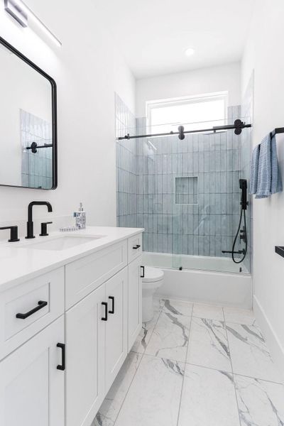 View of 2nd bedroom en-suite bath -Note the sliding shower door