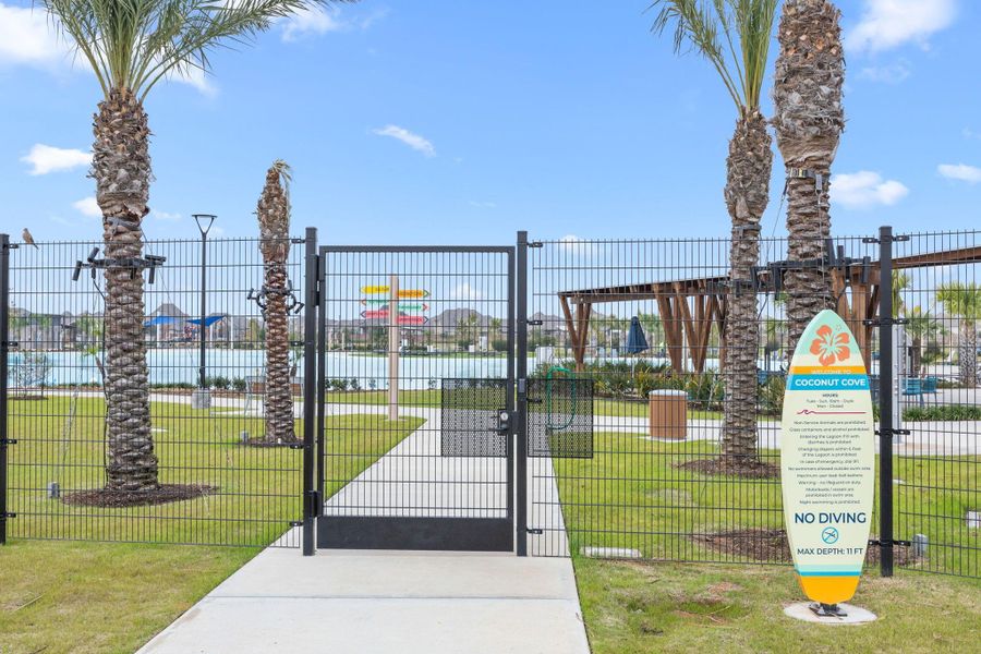 Palm-lined pathways lead to the lagoon area, complete with pavilion seating and controlled resident access.