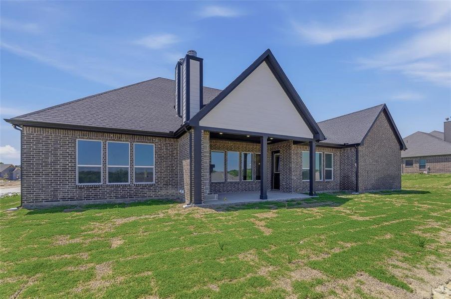 Modern brick exterior with dark shingle roofing