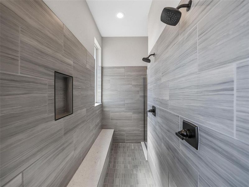 Prior listing photo. Property remains accurate - Full bathroom featuring tiled shower and light tile patterned flooring