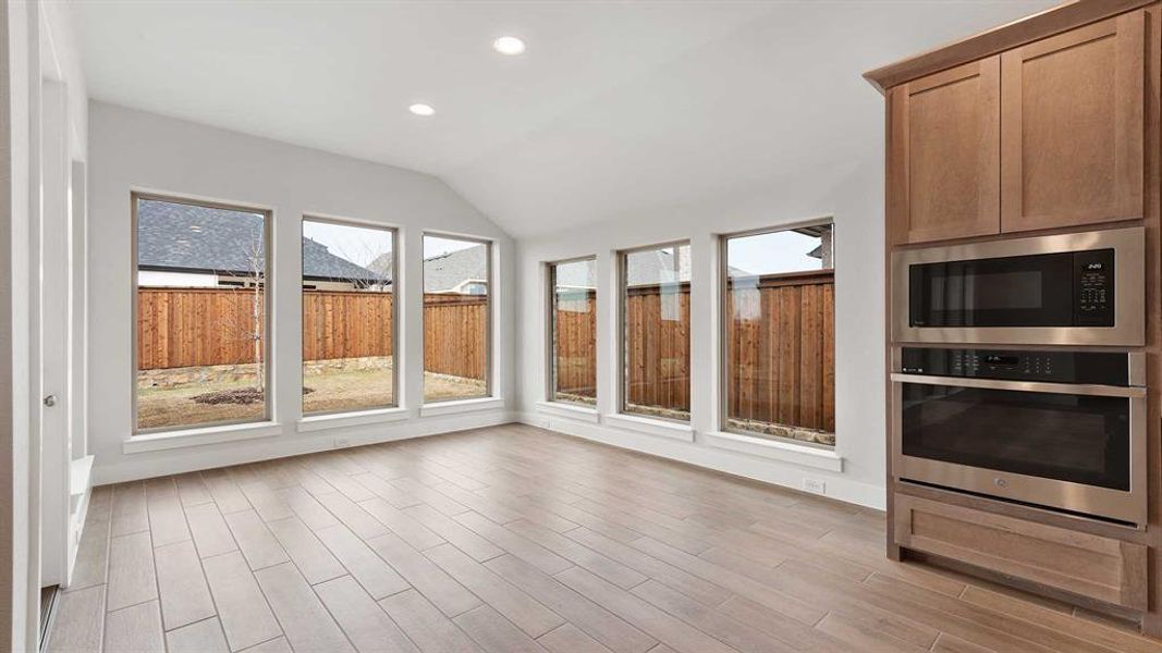 Unfurnished sunroom featuring vaulted ceiling