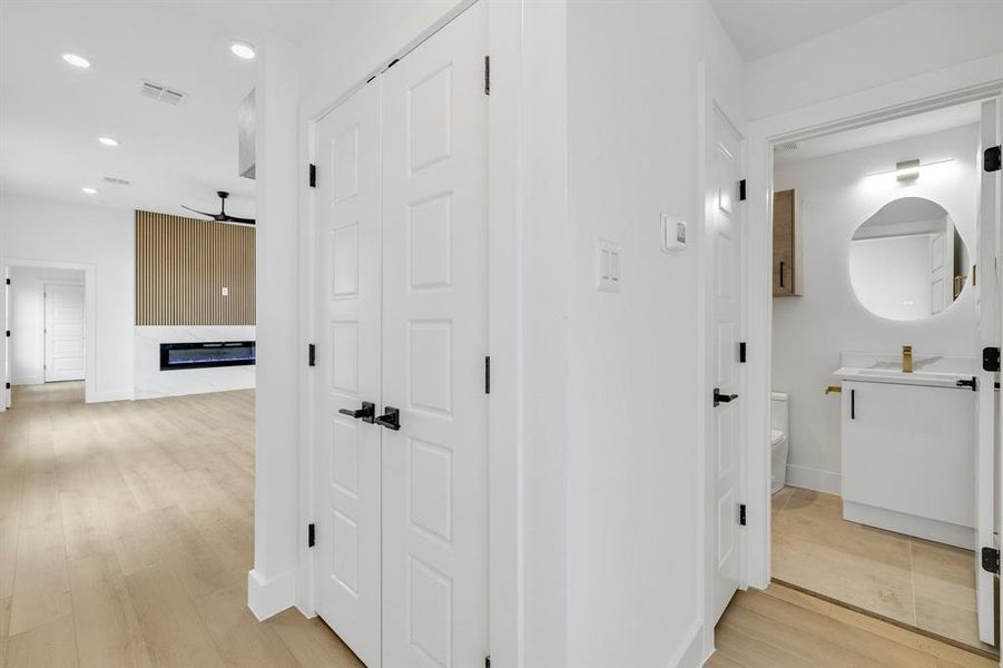 Corridor with light wood finished floors and recessed lighting