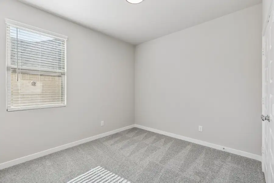 Bedroom in the Holden home plan by Trophy Signature Homes – REPRESENTATIVE PHOTO