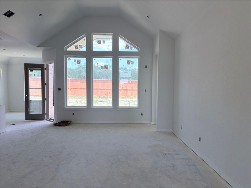 Natural light floods this versatile living area through a distinctive arched window arrangement. Natural light floods this versatile living area through a distinctive arched window arrangement.