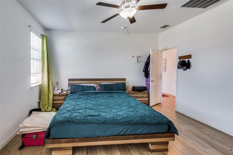 Bedroom with ceiling fan and light wood-type flooring