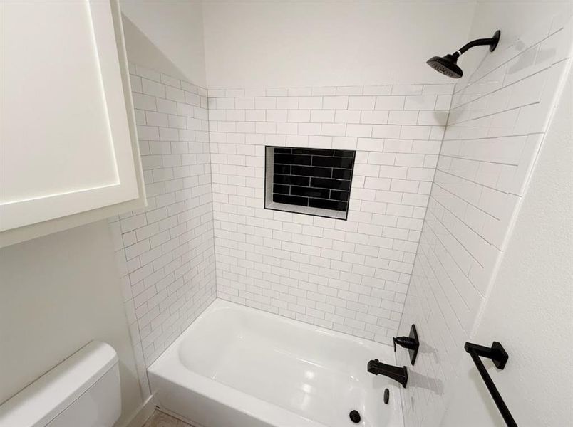 Full bath featuring bathing tub / shower combination and toilet Full bath featuring bathing tub / shower combination and toilet