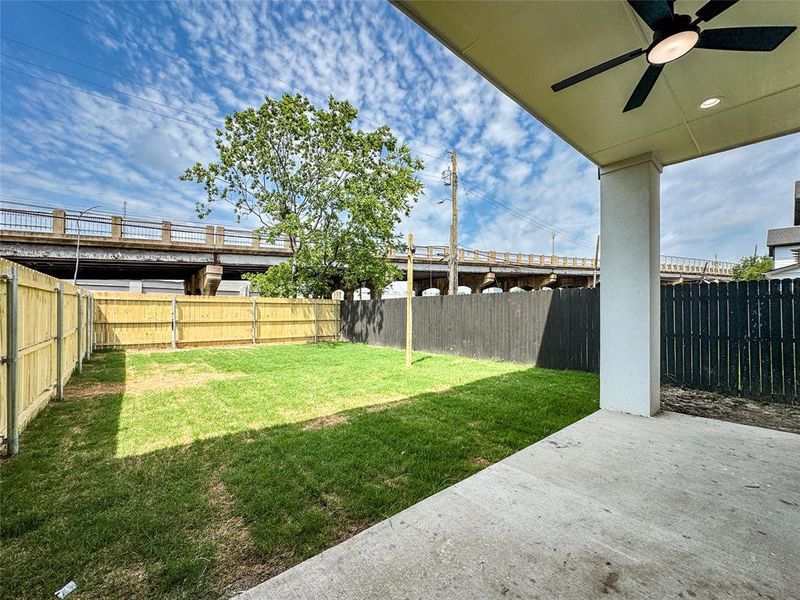 View of yard featuring ceiling fan and a patio area