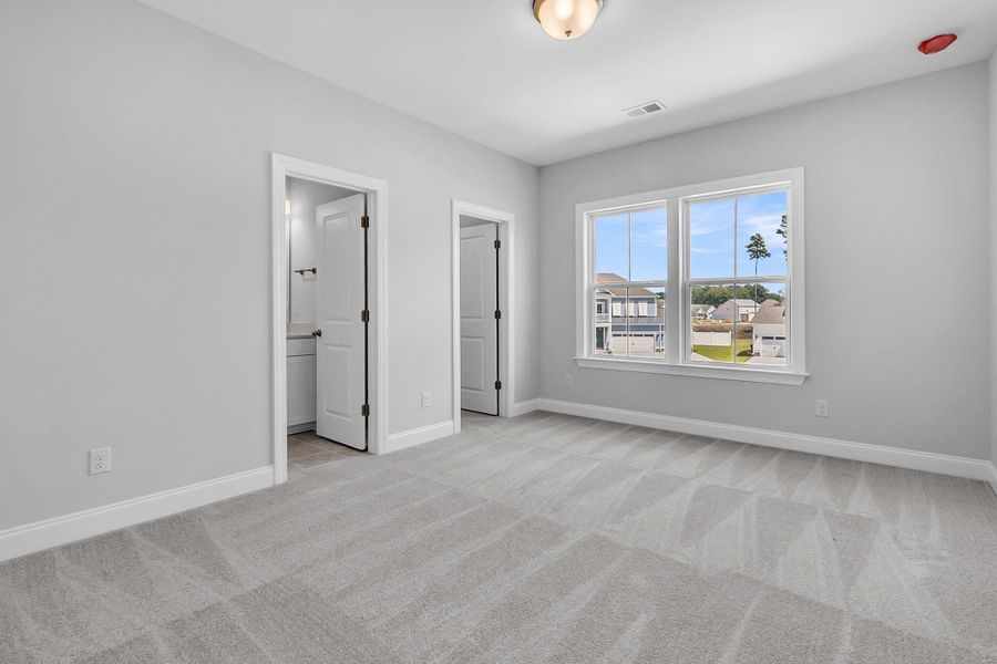 Spacious, unfurnished interior of a new home in Tidewater at Lakes of Cane Bay, Summerville (Image 16).