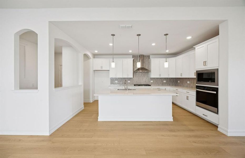 Large island overlooking gathering room and dining areas Large island overlooking gathering room and dining areas