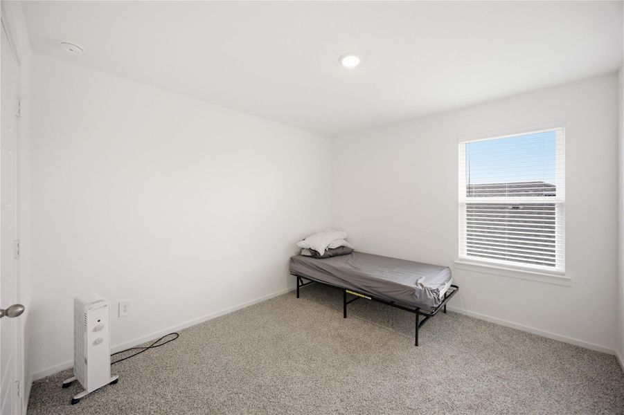 Guest bedroom — Comfortable guest bedroom with natural light. Guest bedroom — Comfortable guest bedroom with natural light.