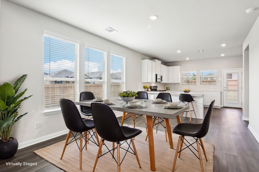 Virtually staged dining room in the Medina floorplan at a Meritage Homes community.