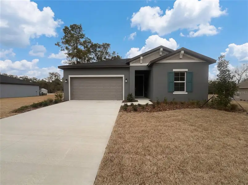 Front exterior of a new home in Grand Park, Dunnellon, FL, highlighting curb appeal (Image 2).