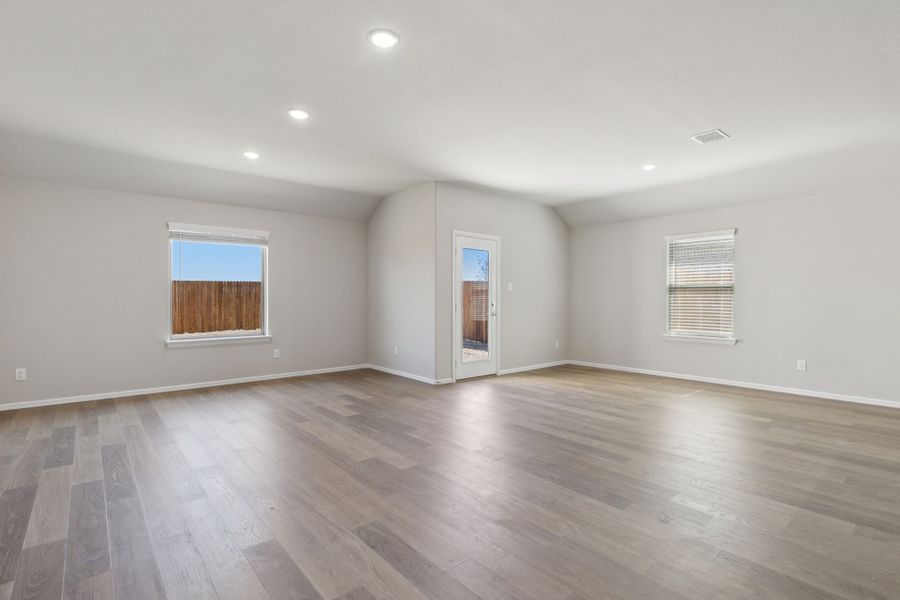 Dining and Living Room in the Harrison home plan by Trophy Signature Homes – REPRESENTATIVE PHOTO