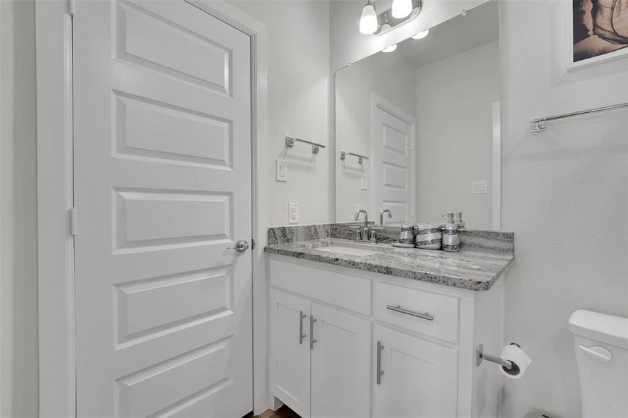 Bathroom featuring vanity and toilet