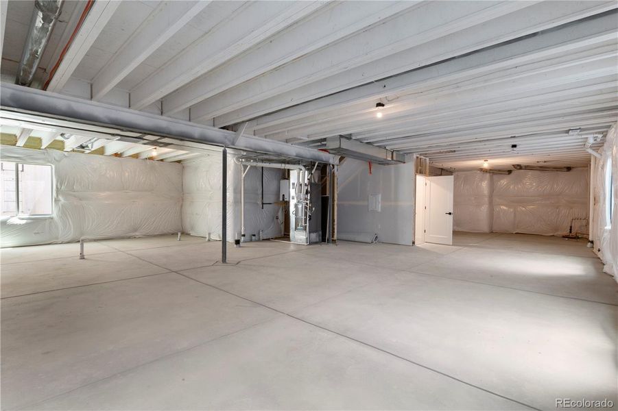 Unfinished lower level with rough in bath and wet bar