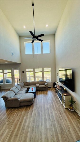 A grand living space with towering ceilings and broad windows offers abundant natural illumination.