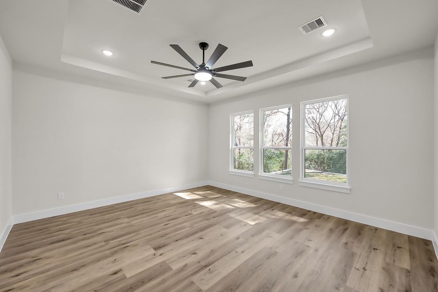 The large owner’s retreat with ample natural light and serene backyard views.