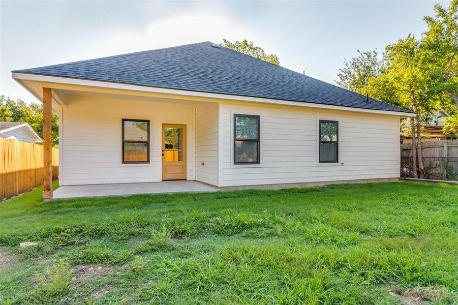 Rear view of house with roof with shingles, a fenced backyard, and a patio Rear view of house with roof with shingles, a fenced backyard, and a patio