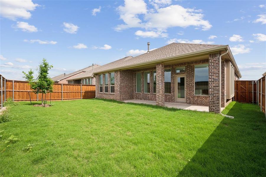 Back of house featuring a patio area and a yard