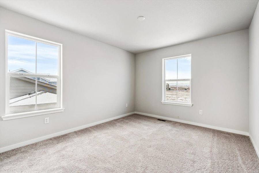 A room with a window and a carpet.