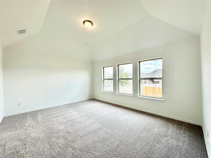 Spare room with vaulted ceiling and carpet Spare room with vaulted ceiling and carpet