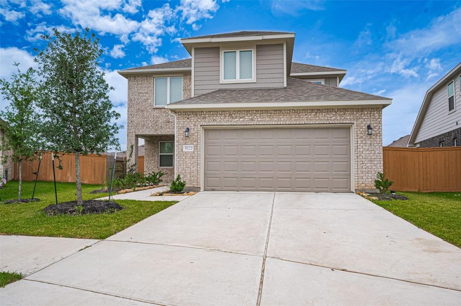 Front exterior of a new home in Sunterra, Katy, TX, highlighting curb appeal (Image 26).