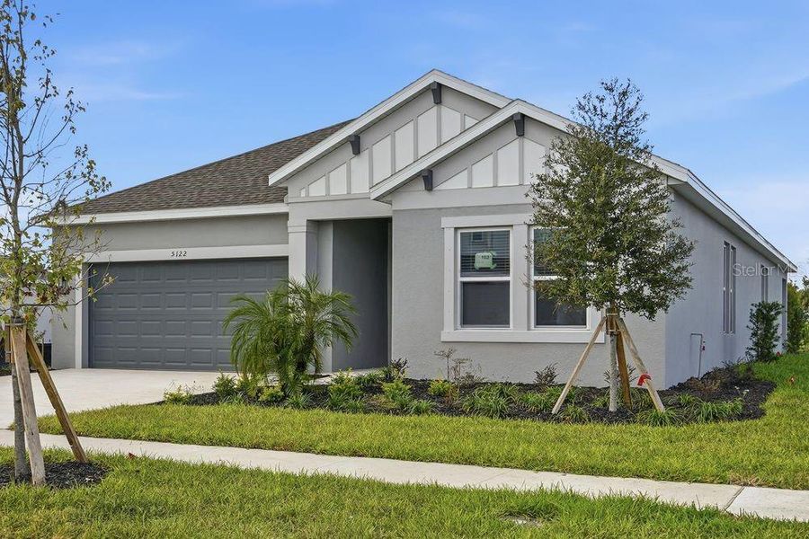 Front exterior of a new home in Indigo Creek, Apollo Beach, FL, highlighting curb appeal (Image 2).