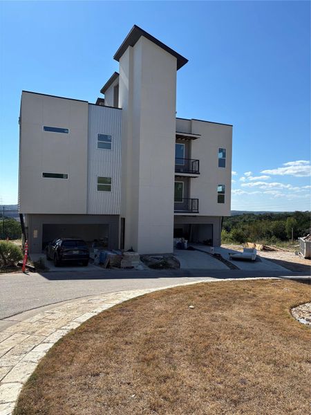 View of property with driveway and an attached garage View of property with driveway and an attached garage
