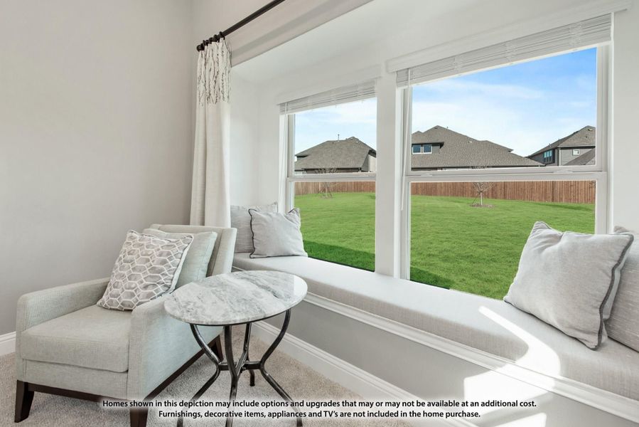 Sitting area with built-in window bench, accent chair, and large windows overlooking a fenced backyard Sitting area with built-in window bench, accent chair, and large windows overlooking a fenced backyard