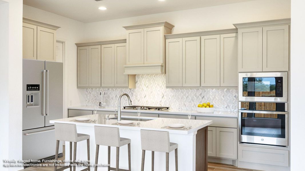 Kitchen with stainless steel appliances, decorative backsplash, light stone countertops, a kitchen breakfast bar, and recessed lighting