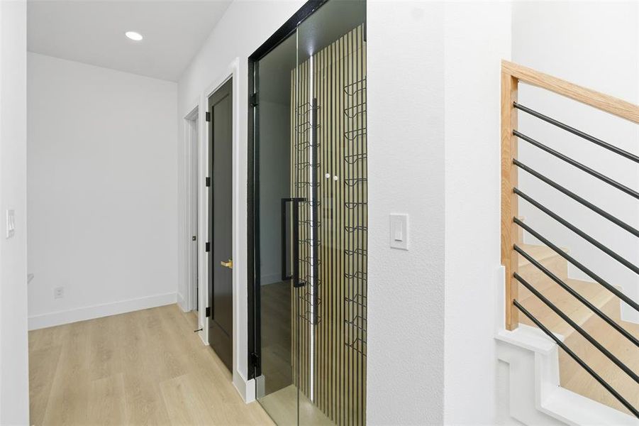 Corridor with light wood finished floors, recessed lighting, and radiator