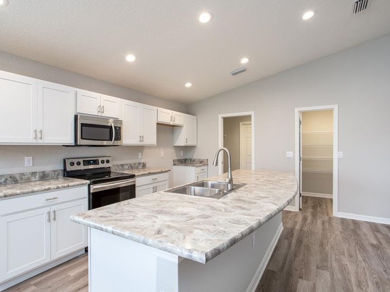 Enjoy your spacious kitchen with luxurious finishes and lots of storage - Photo showcases a home with similar finishes. Colors and design options in actual home for sale may differ.