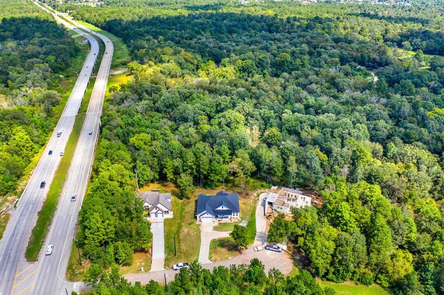 This cud-de-sac lot is home to two completed houses surrounded by dense greenery, offering privacy and a spacious setting.