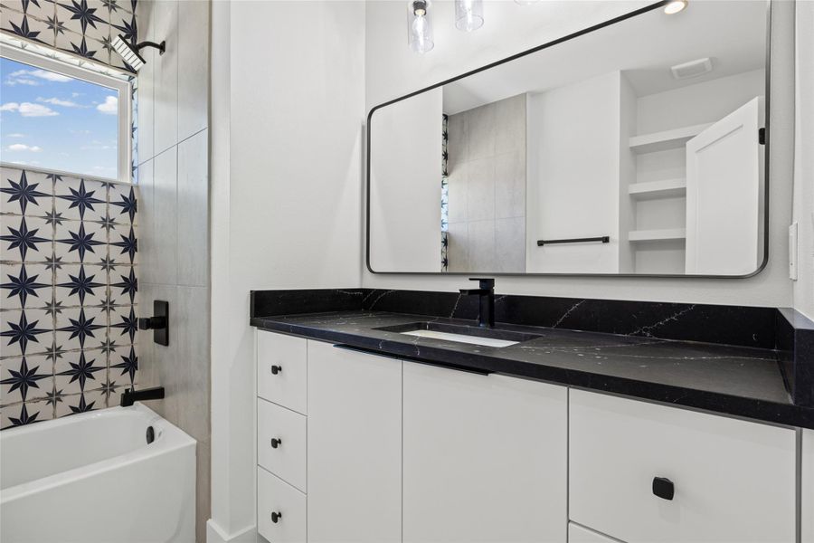 Full bathroom featuring washtub / shower combination and vanity Full bathroom featuring washtub / shower combination and vanity