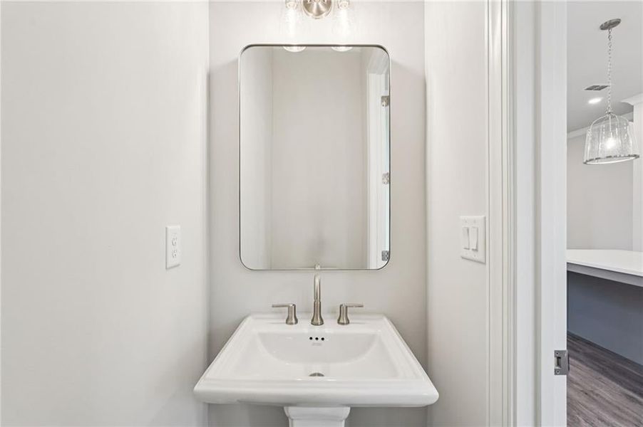 Bathroom with wood finished floors and recessed lighting