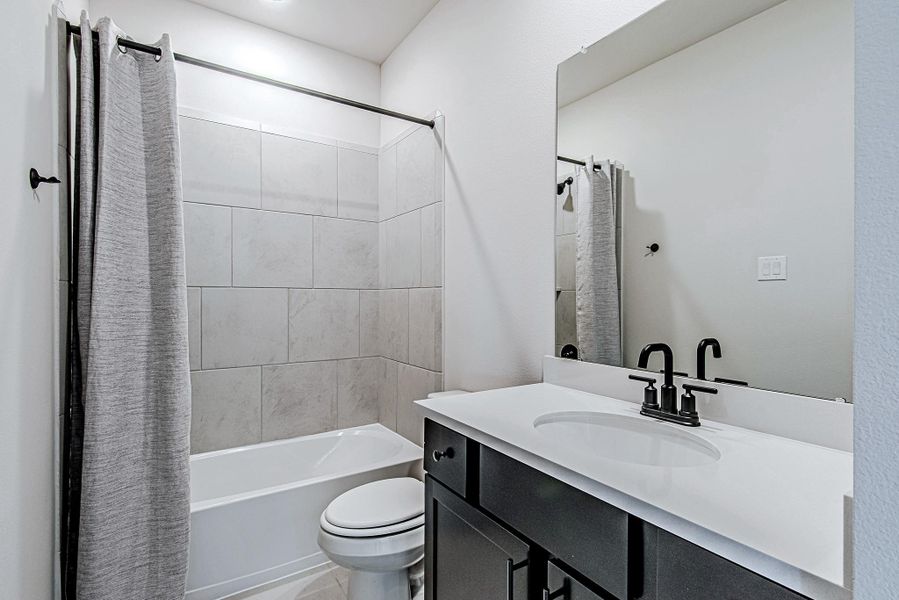 Secondary bathroom with a tub-and-shower combination and modern vanity