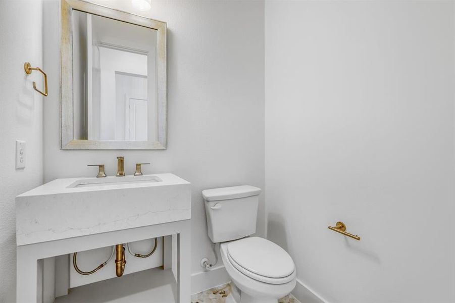 Half bathroom featuring toilet and vanity