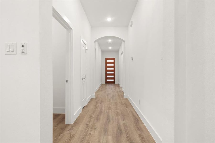 Corridor with light hardwood / wood-style flooring