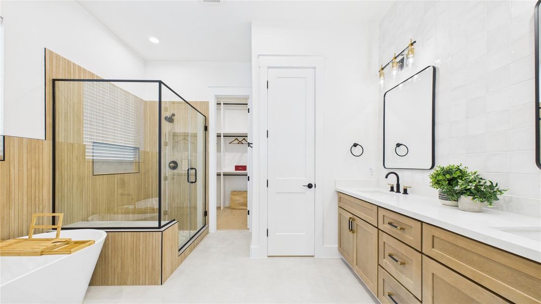 Spa-inspired Primary Bathroom features a free-standing tub, separate shower, and a wide vanity