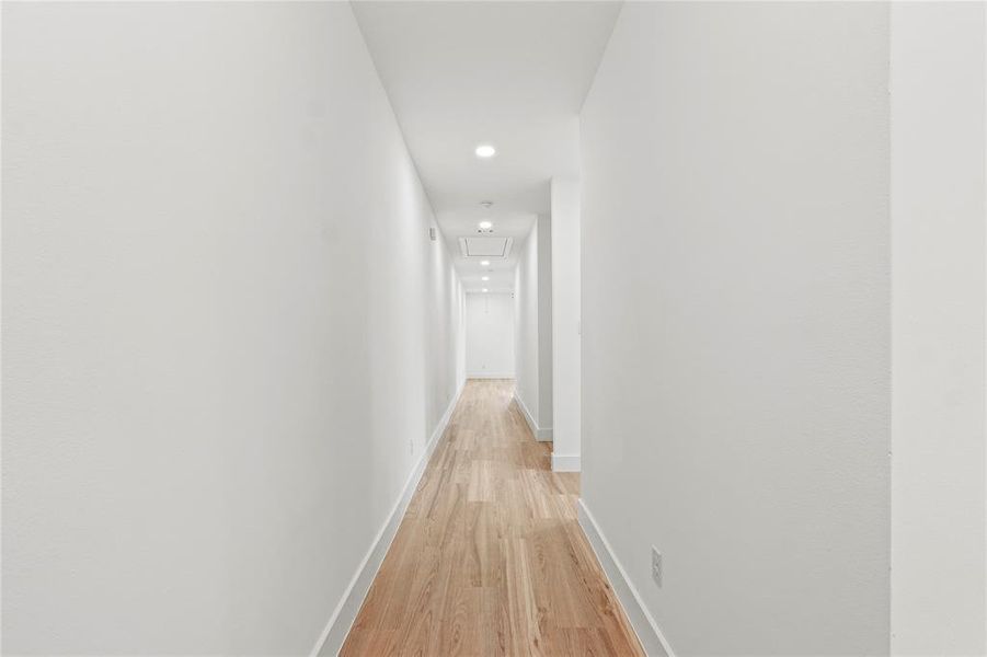Hallway featuring light wood-style flooring and recessed lighting