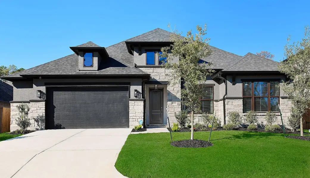 Front exterior of a new home in The Highlands - 65', Porter, TX, highlighting curb appeal (Image 1). Front exterior of a new home in The Highlands - 65', Porter, TX, highlighting curb appeal (Image 1).