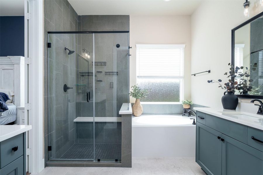 The primary bathroom is a luxurious haven, featuring a tiled walk-in shower, a spacious bathtub for ultimate relaxation, and double sink vanities with sleek custom paint adorned with modern black hardware for a stylish touch. The primary bathroom is a luxurious haven, featuring a tiled walk-in shower, a spacious bathtub for ultimate relaxation, and double sink vanities with sleek custom paint adorned with modern black hardware for a stylish touch.