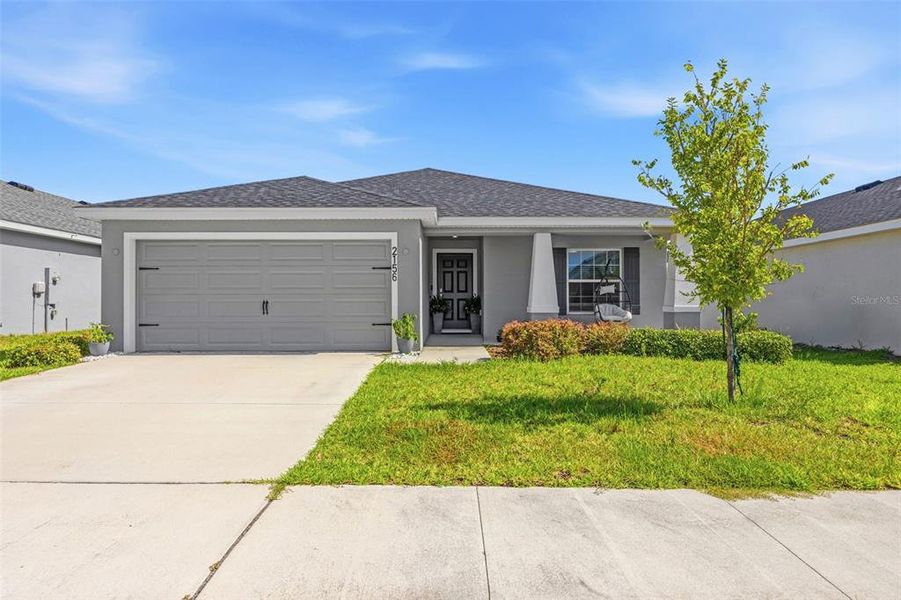Front exterior of a new home in Astonia, Davenport, FL, highlighting curb appeal (Image 23). Front exterior of a new home in Astonia, Davenport, FL, highlighting curb appeal (Image 23).