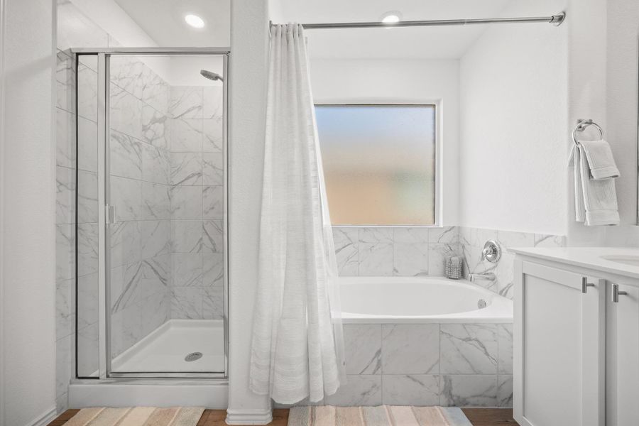 Luxurious primary bath with a separate shower and a generously sized soaking tub. Luxurious primary bath with a separate shower and a generously sized soaking tub.