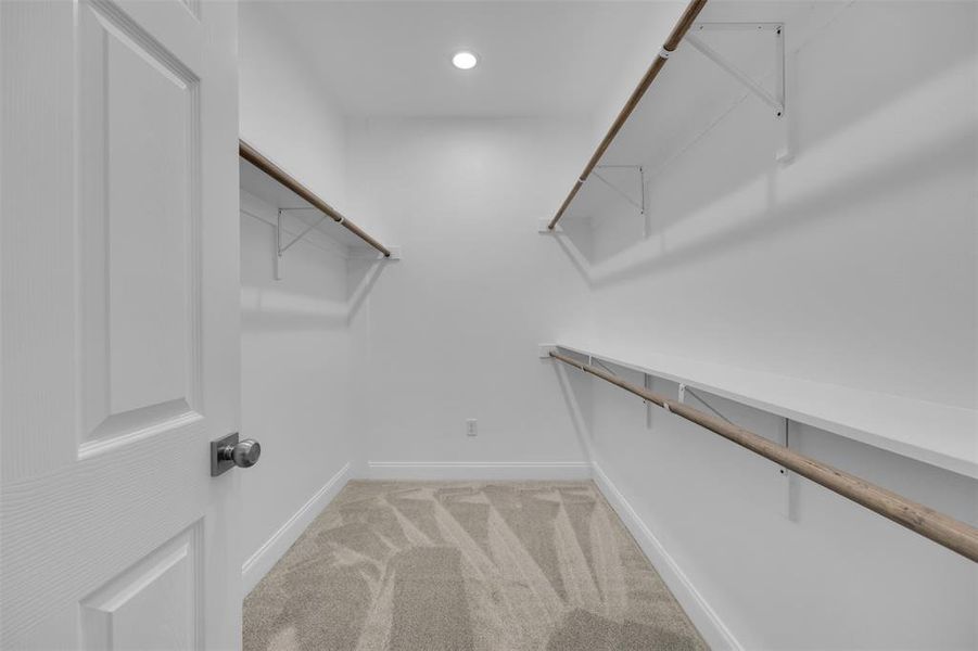 Walk in closet with light colored carpet Walk in closet with light colored carpet