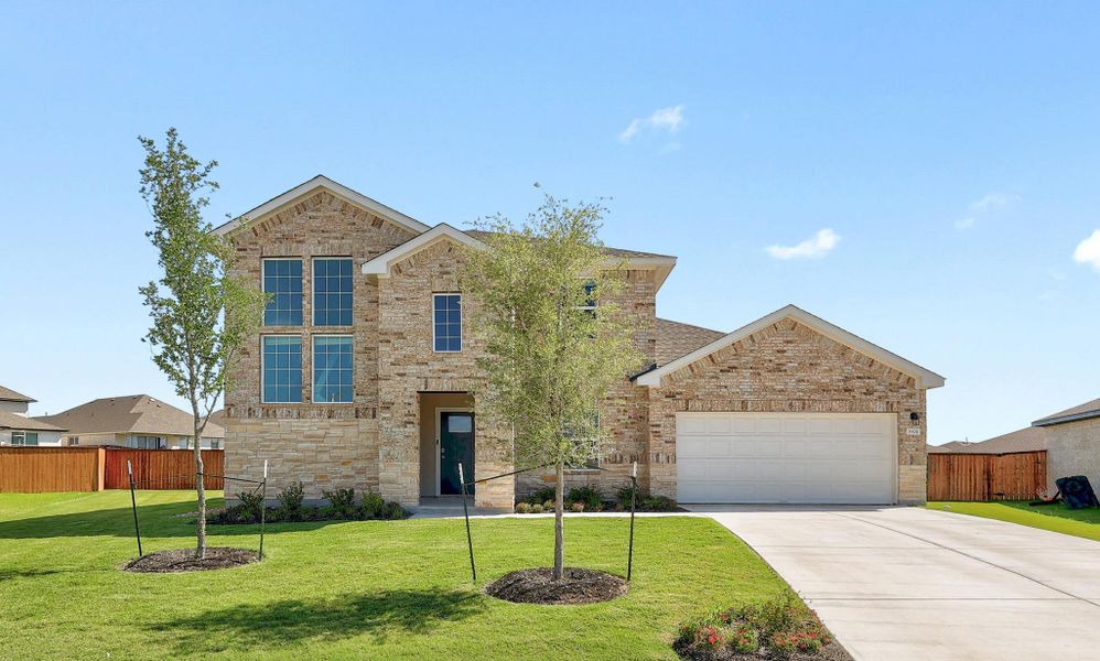 Two-story residence featuring a brick and stone facade Two-story residence featuring a brick and stone facade
