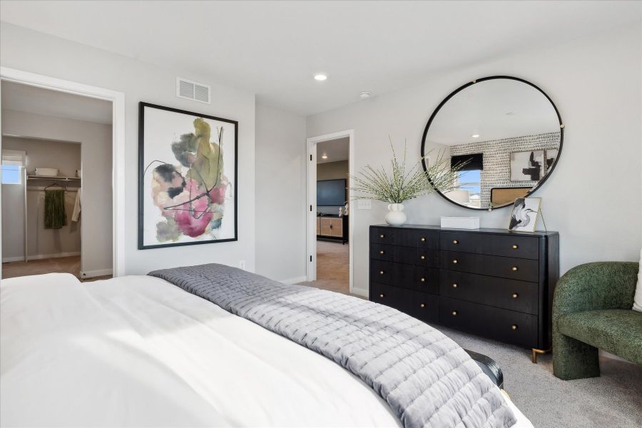A bedroom with a large mirror. A bedroom with a large mirror.